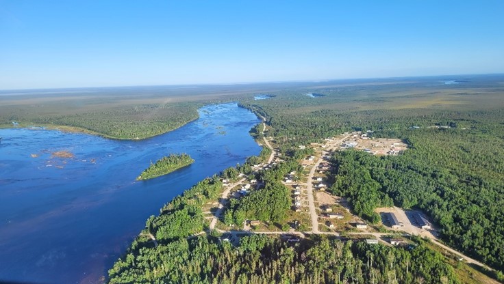 An aerial photo of Marten Falls First Nation and a river.