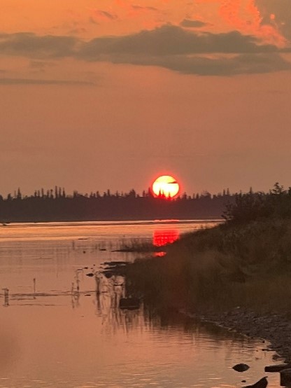 Photo of a sunset in Marten Falls first Nation over the river. Photo of a sunset in Marten Falls first Nation over the river.