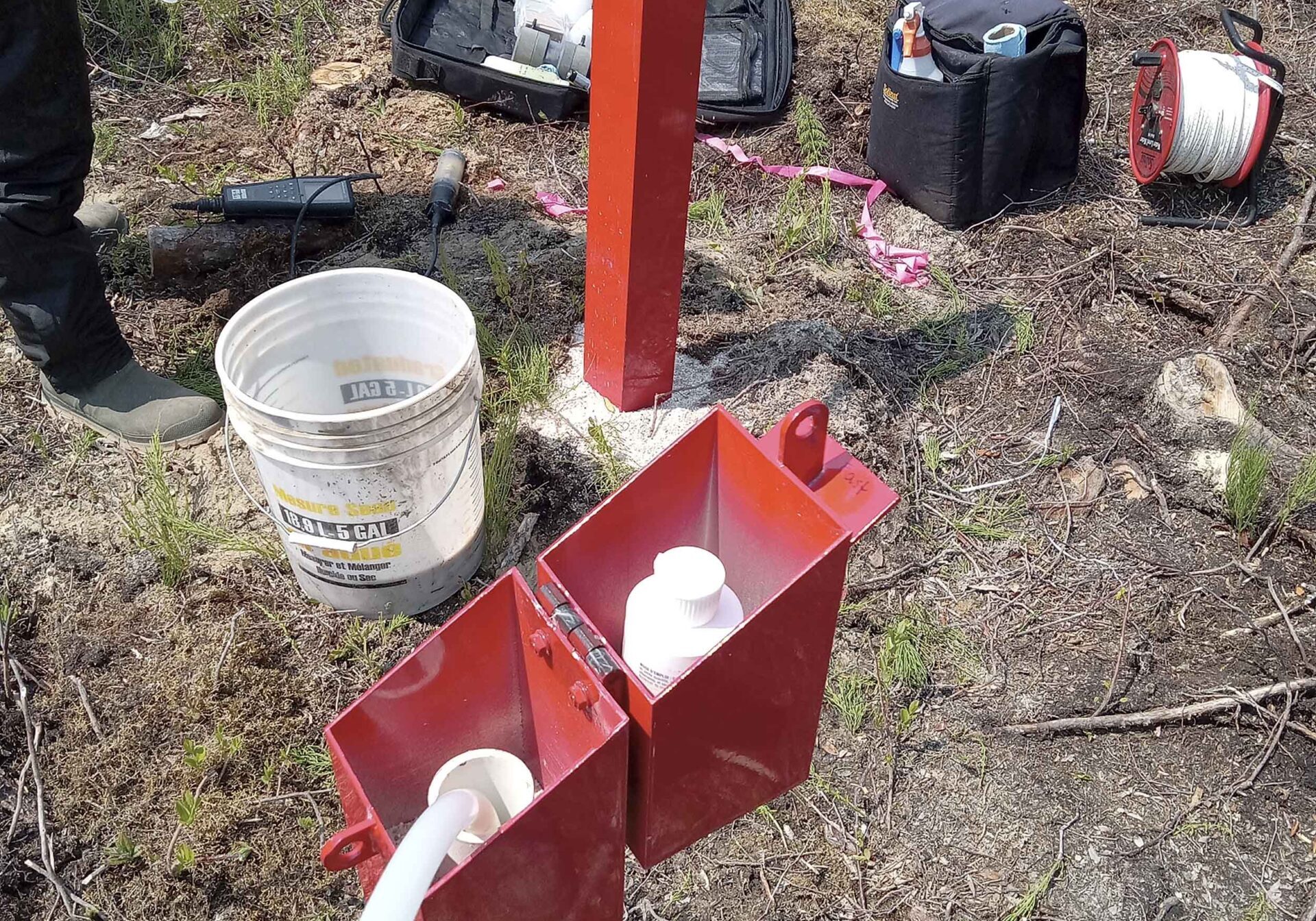 Photo shows two of the monitoring wells being sampled.