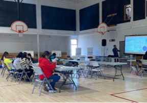 MFFN - Community Photo of a group of individuals sitting watching a presentation.
